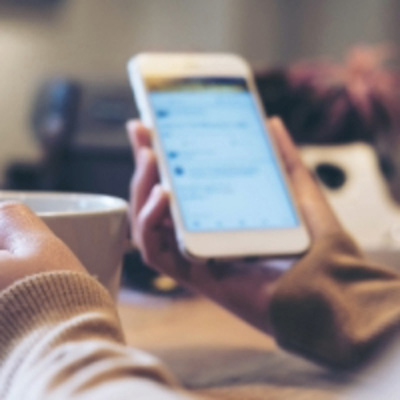 Person checking the latest news items on their phone